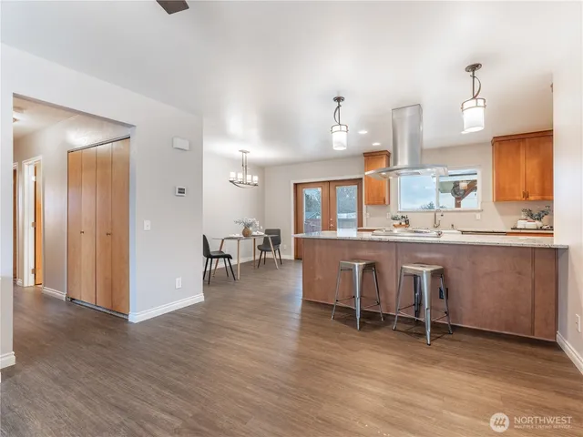 a view of a dining room with furniture wooden floor and a chandelier