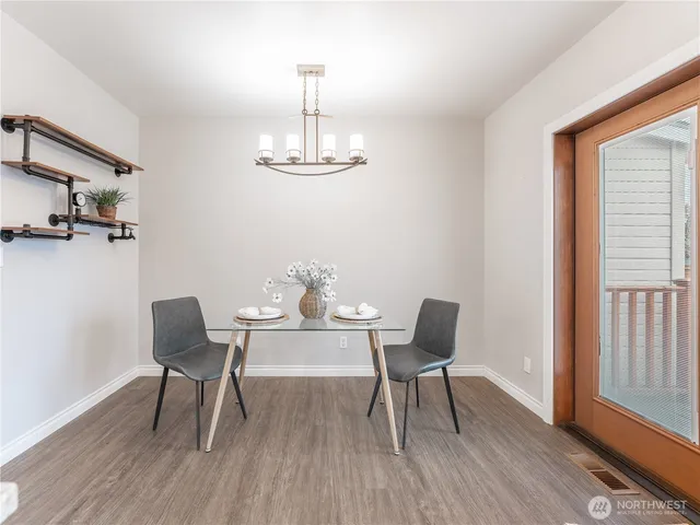 a kitchen with granite countertop a white cabinets and chairs