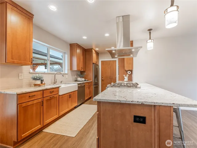 a kitchen with a sink and chairs