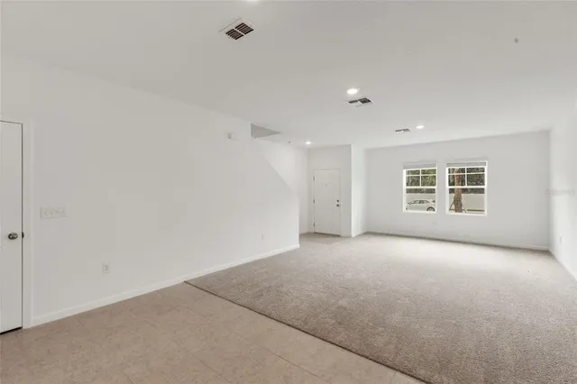 an empty room with a empty space and windows