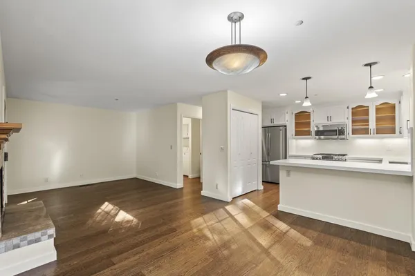 a open kitchen with stainless steel appliances granite countertop a refrigerator and a stove top oven