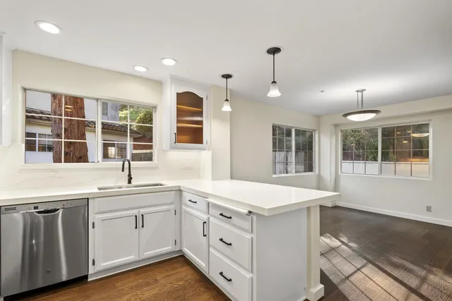 a kitchen with a sink stove and cabinets