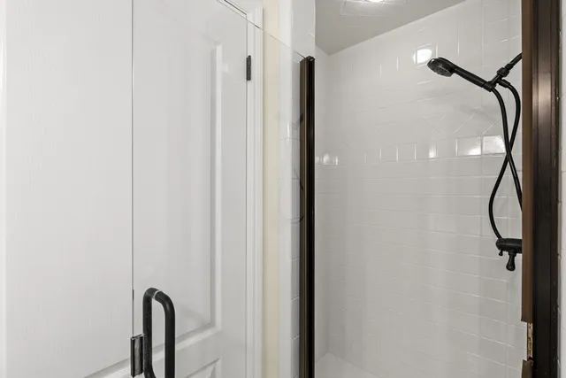 a bathroom with a glass door shower