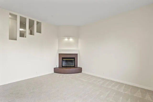 a view of an empty room with a fireplace