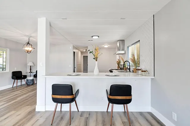 a kitchen with a table and chairs