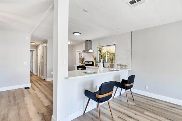 a kitchen with a table and chairs in it