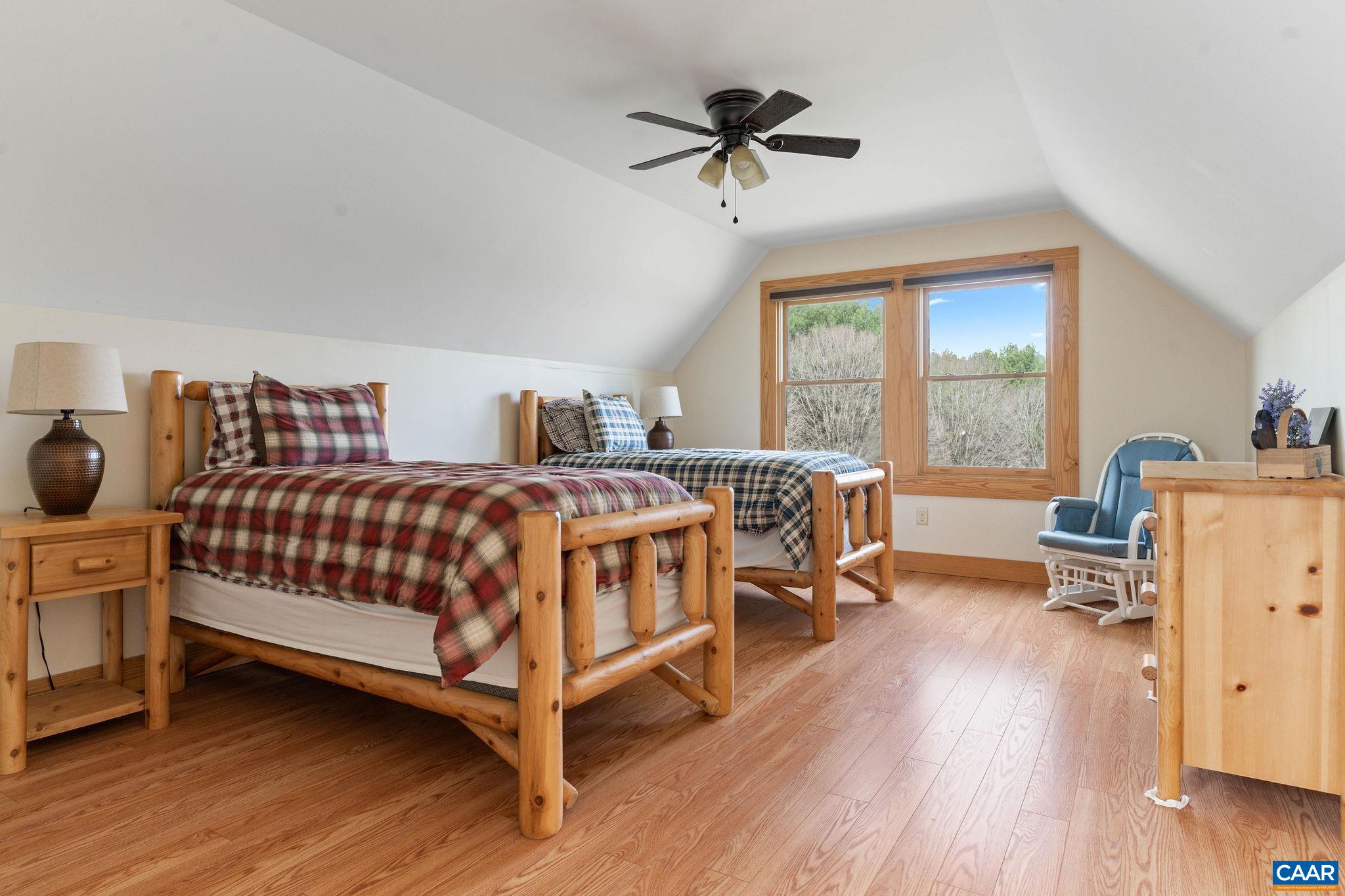 42 River Ridge Lane Stanardsville, VA 22973 - Photo 62 of 70 a bedroom with a bed a table and a chandelier