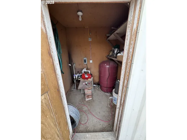 a living room with furniture a floor to ceiling window and wooden floor