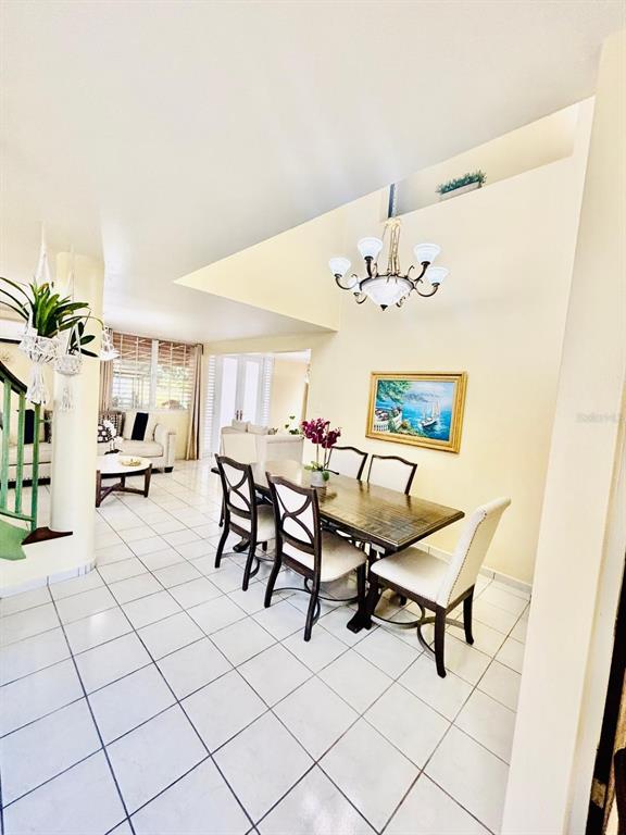 1 St Rio Grande, Unit B6 Rio Grande, PR 00745 - Photo 24 of 47 a living room with furniture and a chandelier