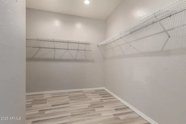 an empty room with a window and ceiling fan