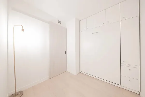a large white bed in a white room