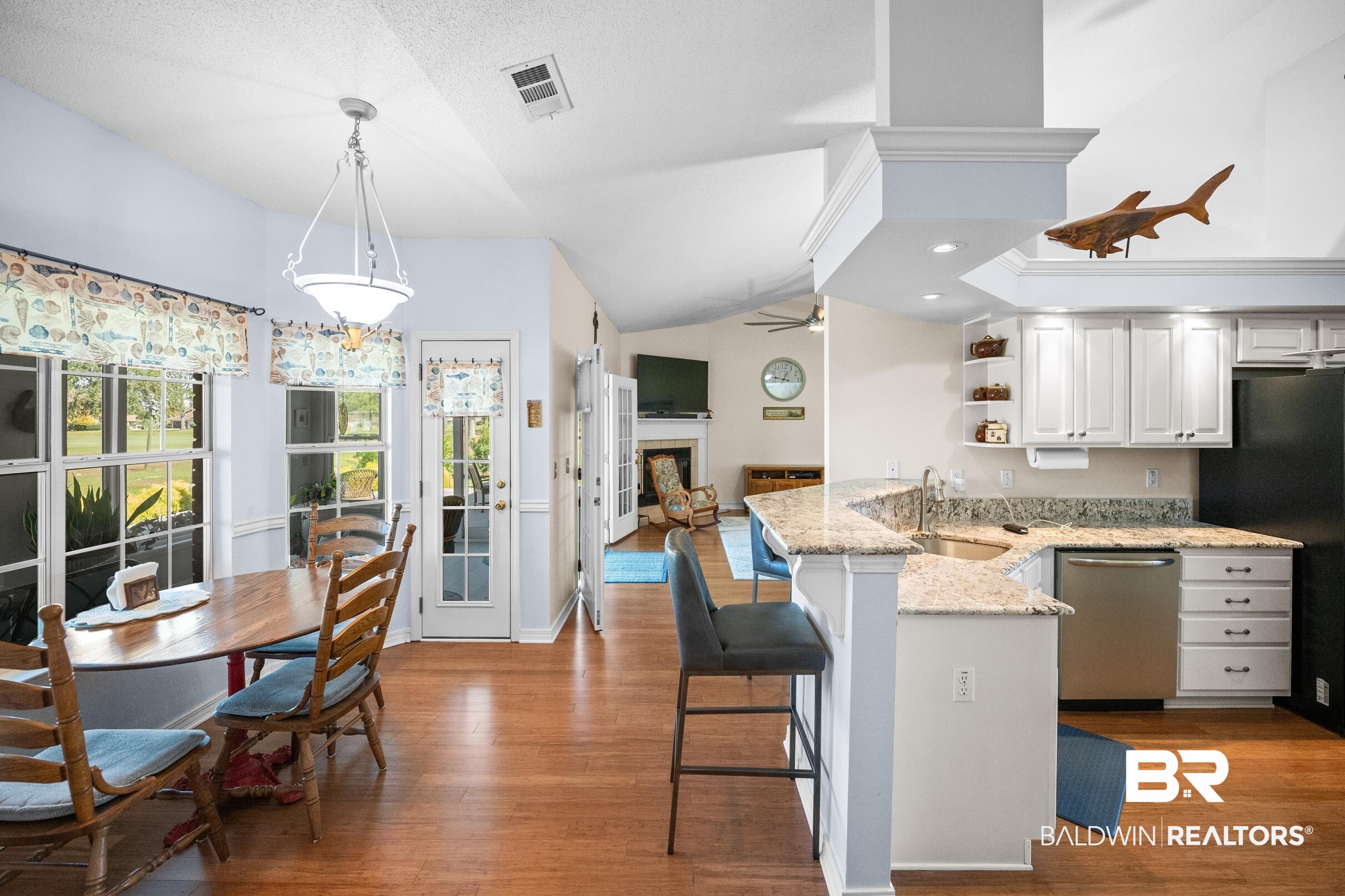 22355 East County Road 12 Foley, AL 36535 - Photo 21 of 54 Kitchen featuring light stone counters, white cabinetry, lofted ceiling, stainless steel dishwasher, and light wood-style flooring