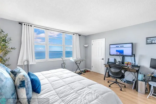 a living room with furniture and a view of kitchen