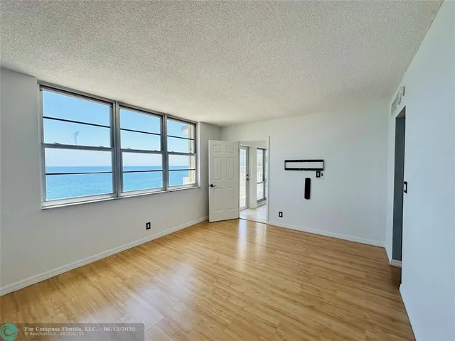 a living room with furniture and a book shelf