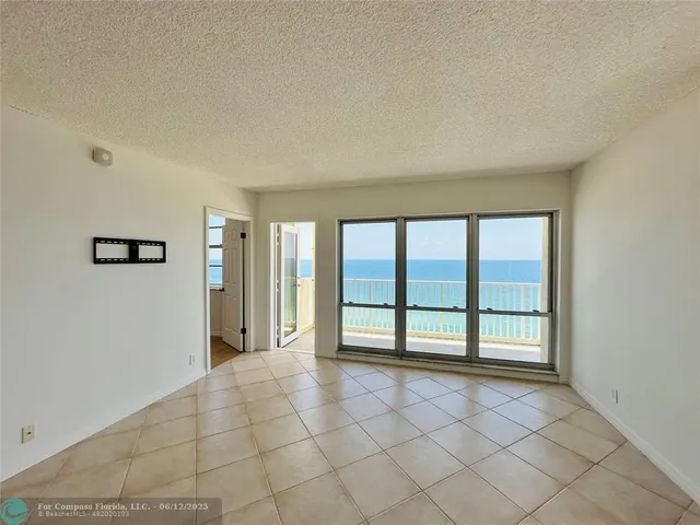 a kitchen with stainless steel appliances granite countertop a refrigerator a sink and white cabinets