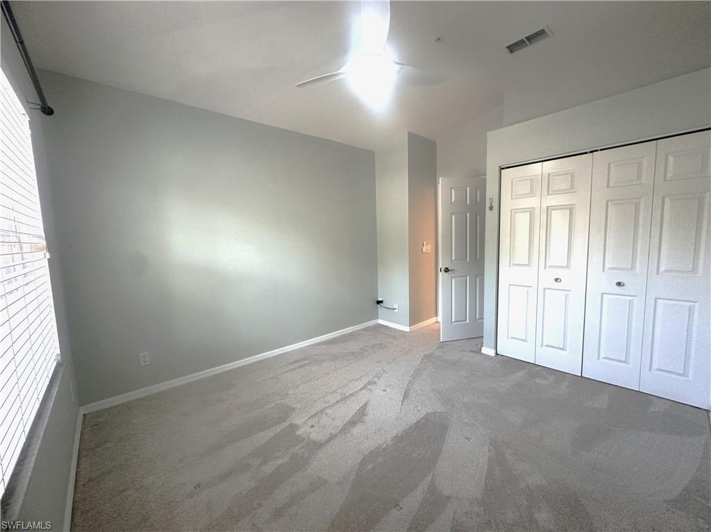 6922 Satinleaf Road North, Unit 203 Naples, FL 34109 - Photo 11 of 31 an empty room with windows