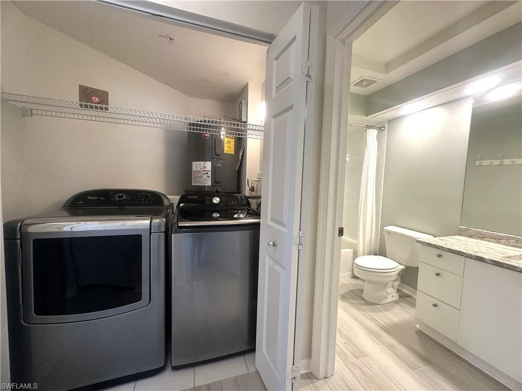 6922 Satinleaf Road North, Unit 203 Naples, FL 34109 - Photo 12 of 31 a bathroom with a toilet and a shower