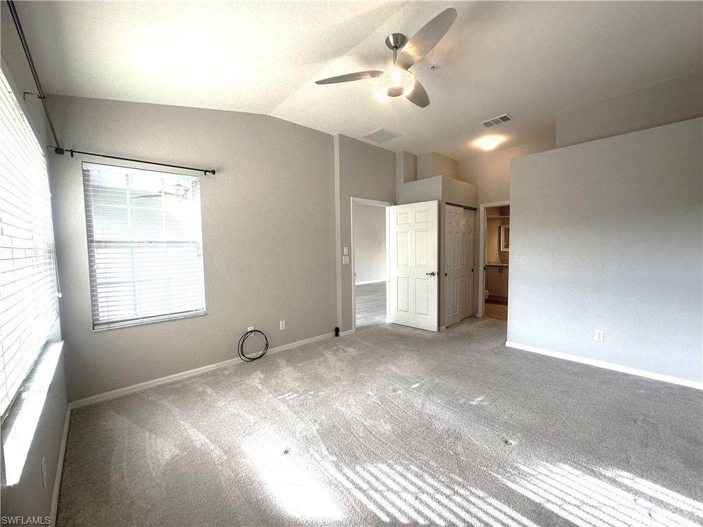6922 Satinleaf Road North, Unit 203 Naples, FL 34109 - Photo 14 of 31 a view of empty room with windows