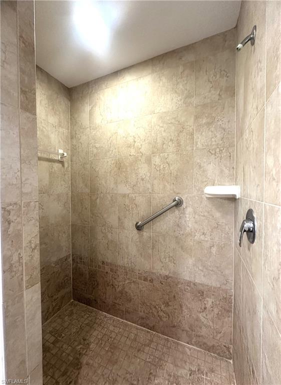 6922 Satinleaf Road North, Unit 203 Naples, FL 34109 - Photo 20 of 31 a bathroom with a shower