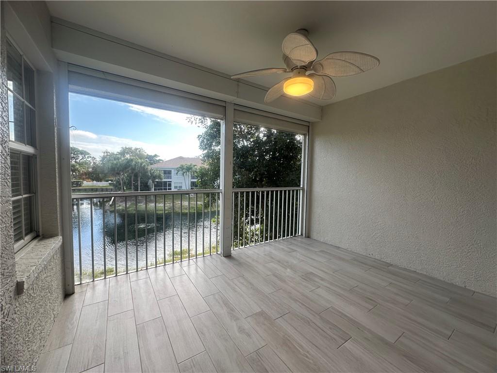 6922 Satinleaf Road North, Unit 203 Naples, FL 34109 - Photo 22 of 31 a view of a lake from a balcony