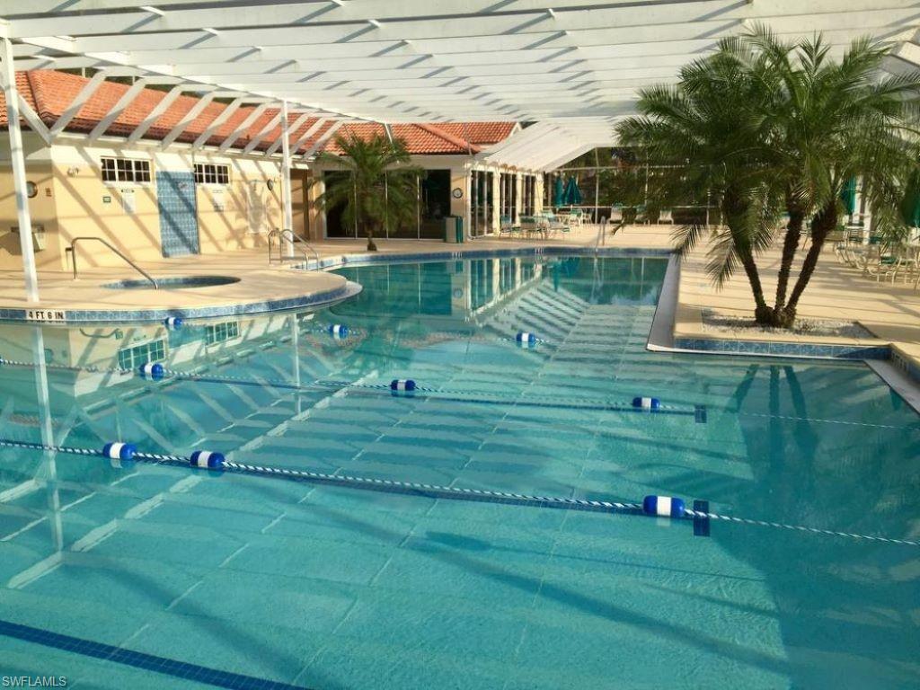 6922 Satinleaf Road North, Unit 203 Naples, FL 34109 - Photo 25 of 31 a view of a house with a yard