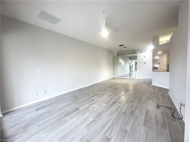 a view of a room with wooden floor and a window