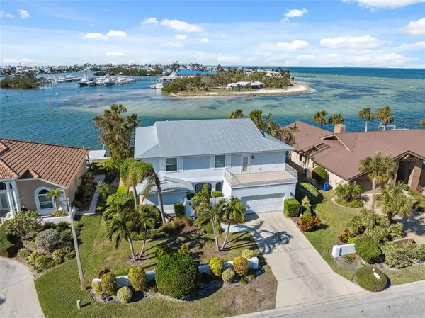 an aerial view of a house with garden space and ocean view