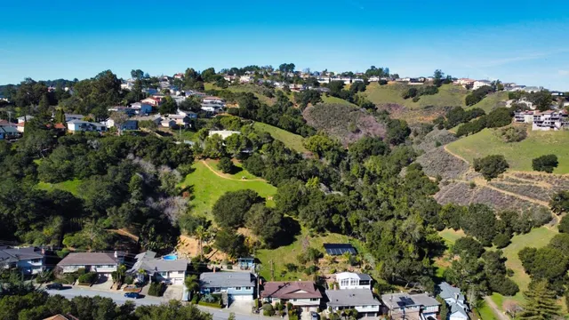 an aerial view of houses with yard