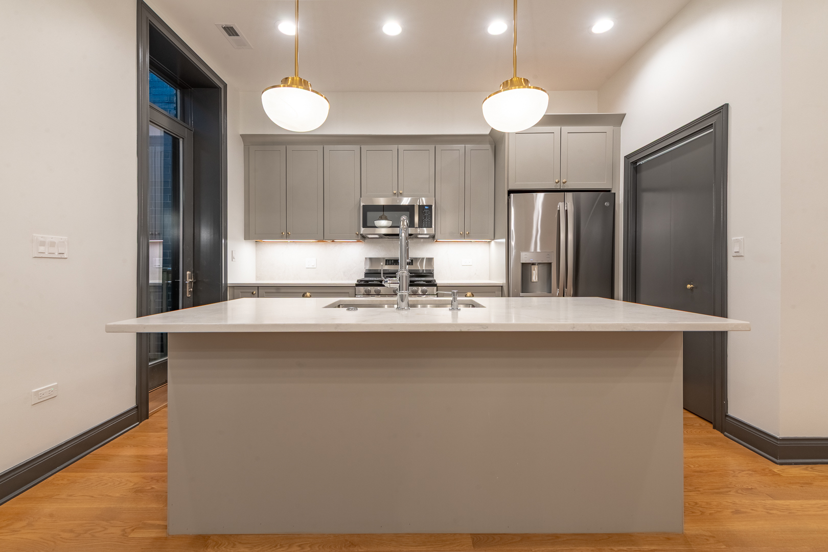 28 North Throop Street, Unit 2 Chicago, IL 60607 - Photo 11 of 35 a kitchen with stainless steel appliances a dining table chairs and a refrigerator