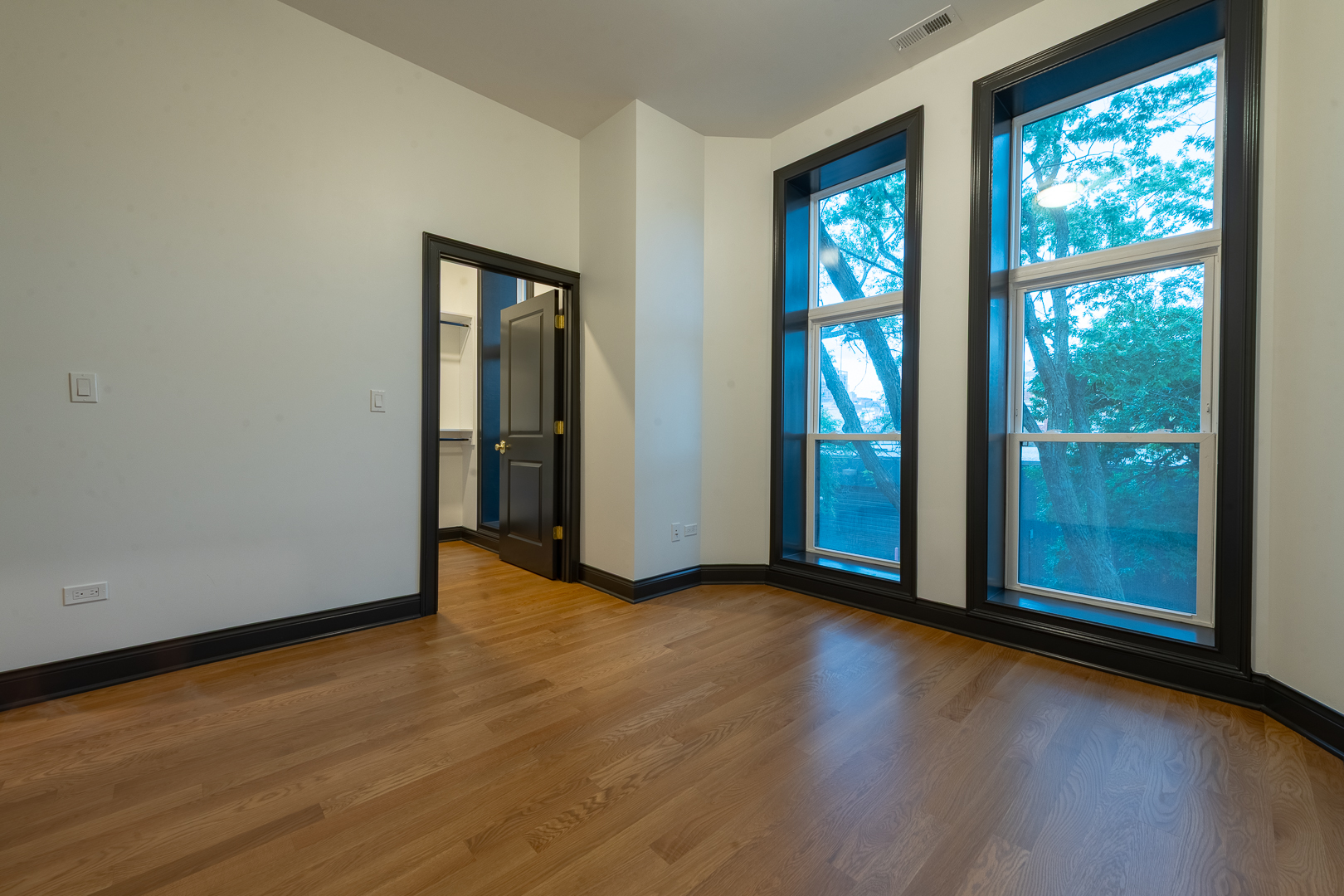 28 North Throop Street, Unit 2 Chicago, IL 60607 - Photo 20 of 35 an empty room with wooden floor and windows