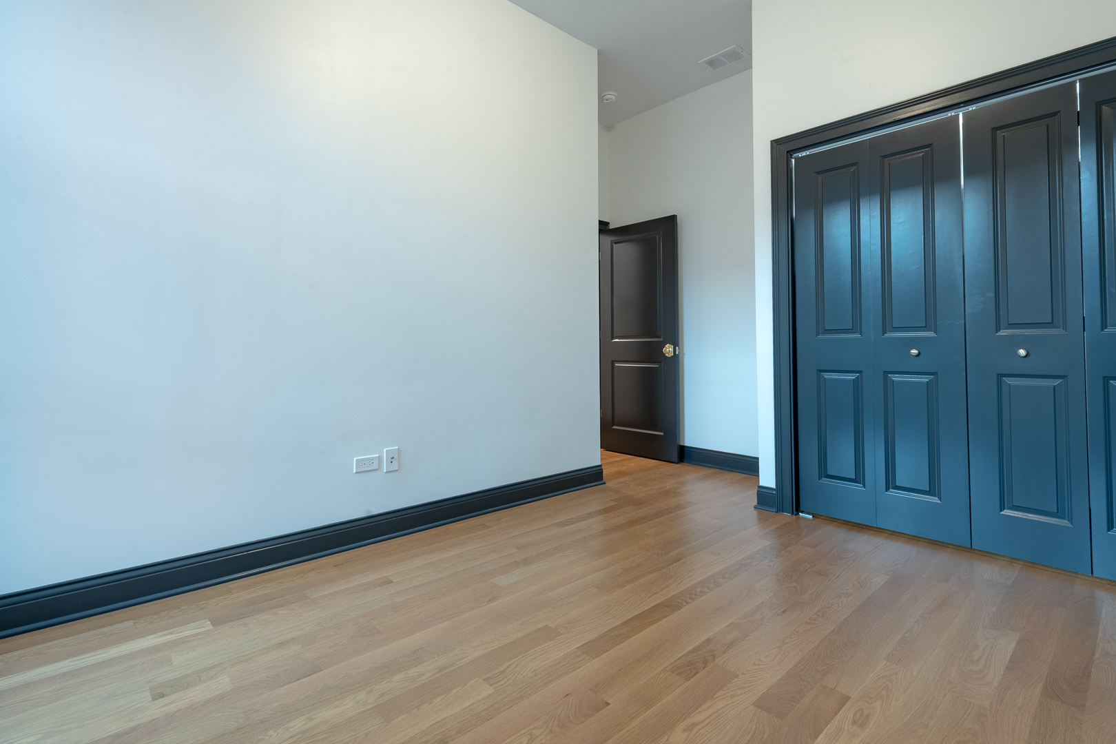 28 North Throop Street, Unit 2 Chicago, IL 60607 - Photo 27 of 35 a view of an empty room with closet and wooden floor