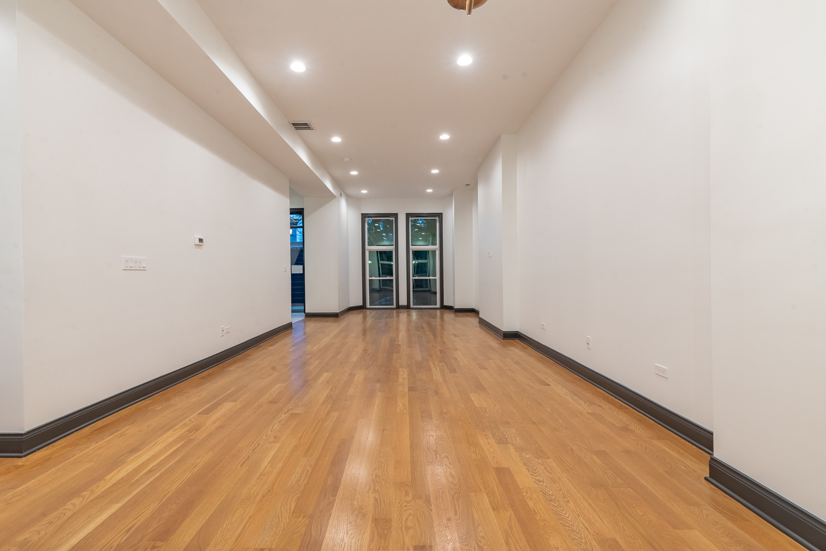 28 North Throop Street, Unit 2 Chicago, IL 60607 - Photo 5 of 35 an empty room with wooden floor and natural light