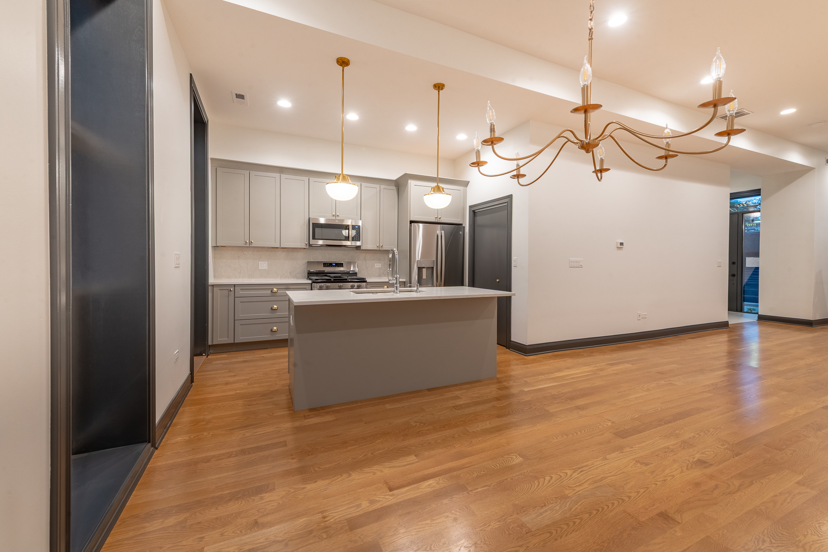 28 North Throop Street, Unit 2 Chicago, IL 60607 - Photo 8 of 35 a view of a kitchen with a sink and cabinet with a projector screen