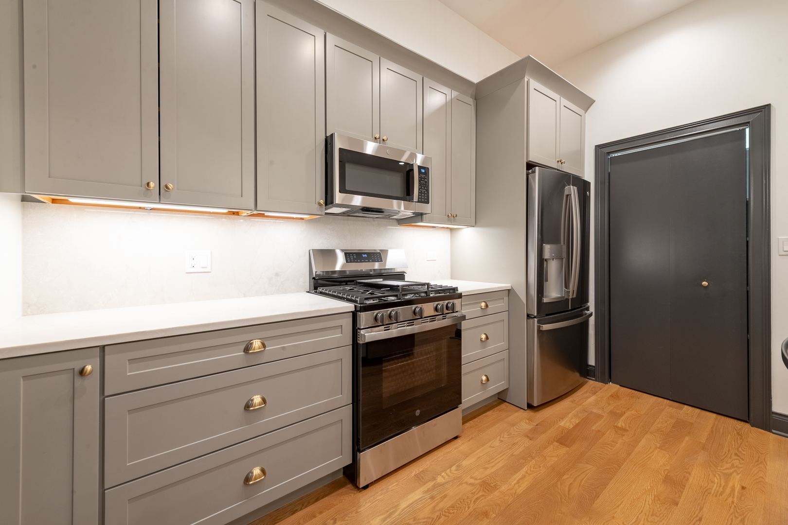 28 North Throop Street, Unit 2 Chicago, IL 60607 - Photo 9 of 35 a kitchen with stainless steel appliances granite countertop a refrigerator stove and sink