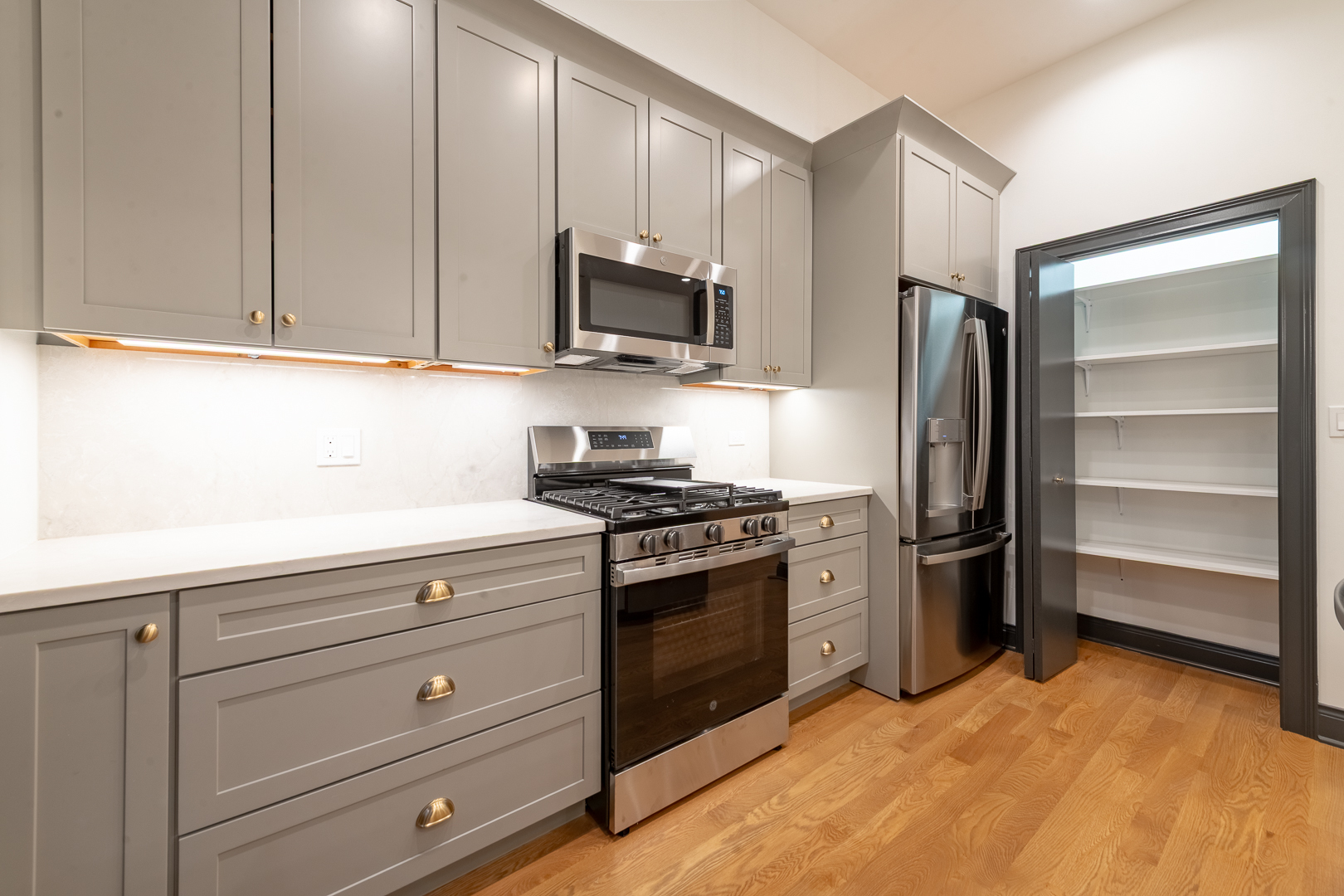 28 North Throop Street, Unit 2 Chicago, IL 60607 - Photo 10 of 35 a kitchen with stainless steel appliances granite countertop a refrigerator and a stove top oven