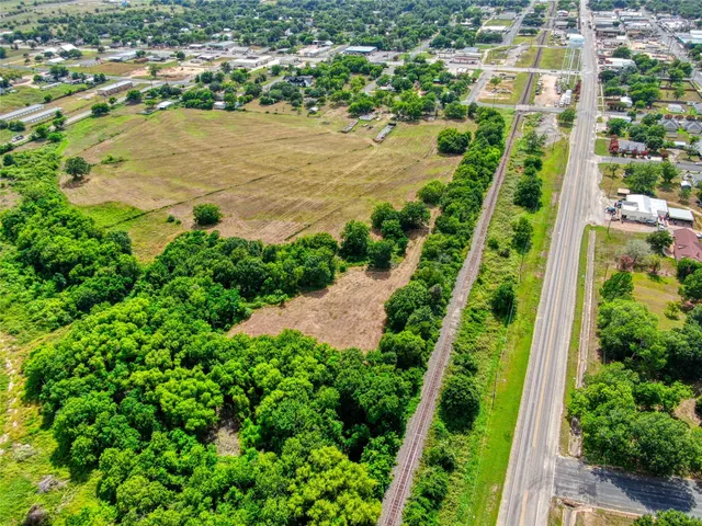 an aerial view of ocean with residential house and green space