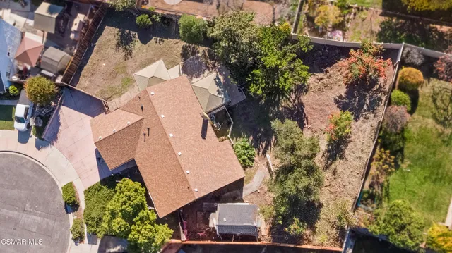 an aerial view of a house with a yard and garden