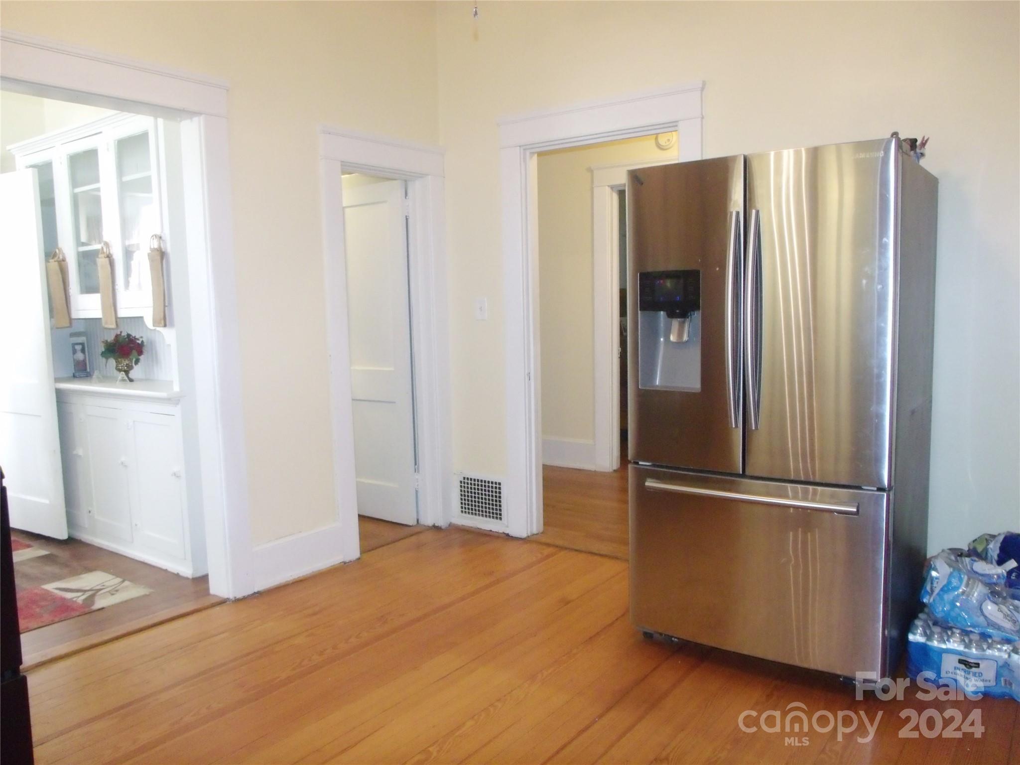 143 Lancaster Street Chester, SC 29706 - Photo 13 of 29 a kitchen with stainless steel appliances wooden floor and a refrigerator