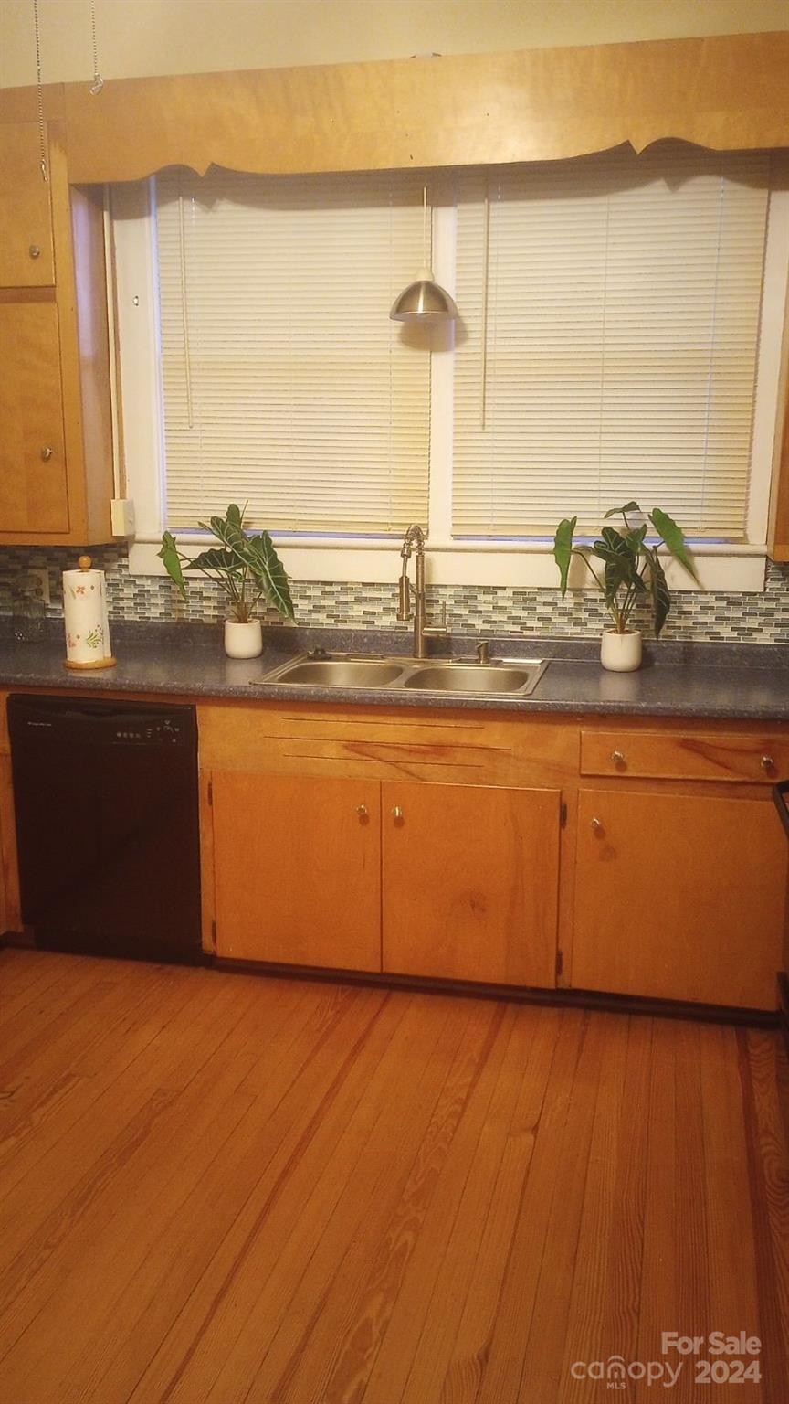 143 Lancaster Street Chester, SC 29706 - Photo 14 of 29 a large kitchen with granite countertop a sink and a wooden floor