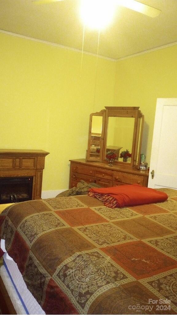 143 Lancaster Street Chester, SC 29706 - Photo 17 of 29 a bedroom with a bed and wooden floor