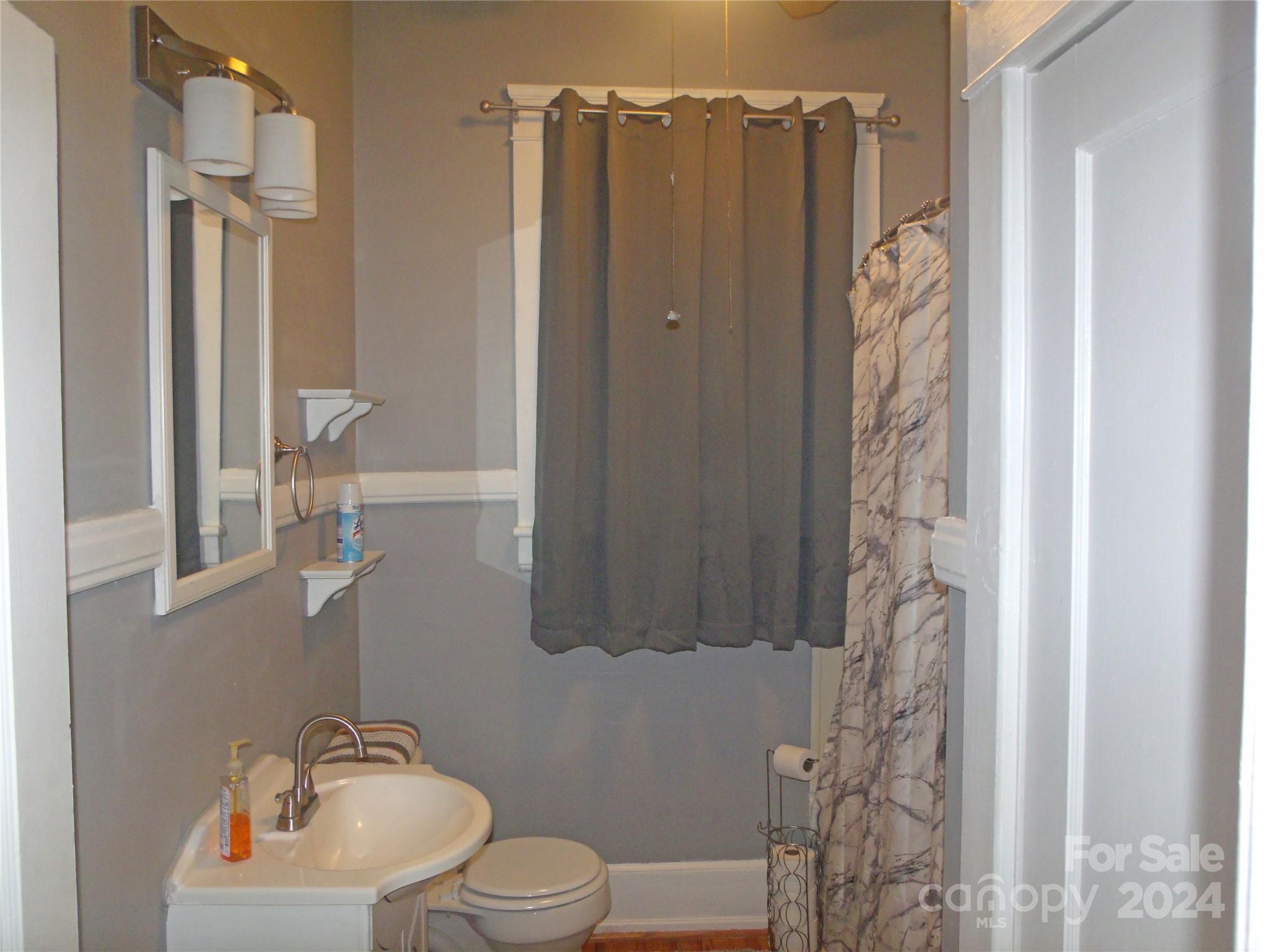 143 Lancaster Street Chester, SC 29706 - Photo 22 of 29 a bathroom with a shower a toilet and sink
