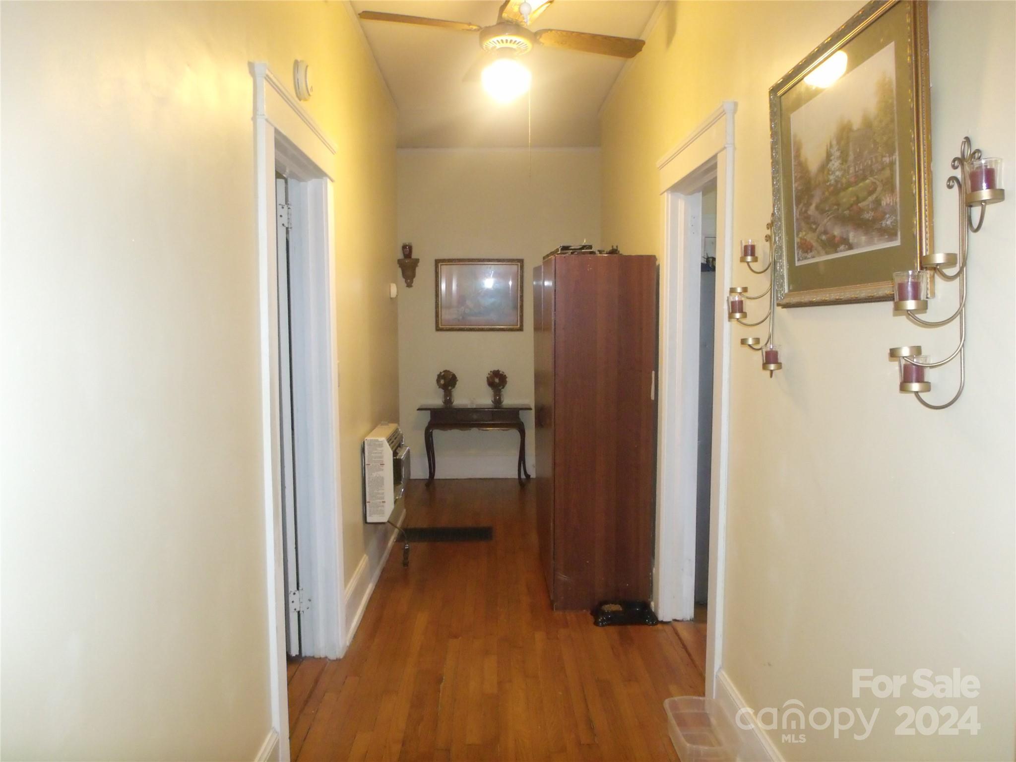 143 Lancaster Street Chester, SC 29706 - Photo 9 of 29 a view of a hallway with wooden floor and a bathroom