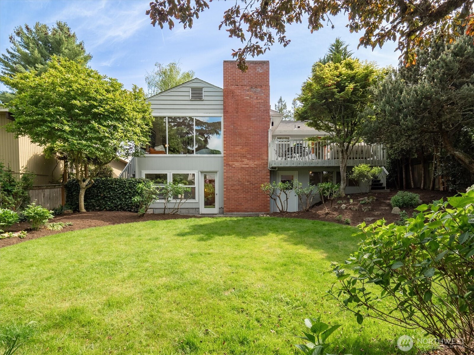 6420 Northeast 60th Street Seattle, WA 98115 - Photo 1 of 40 a view of a big yard with plants and large trees