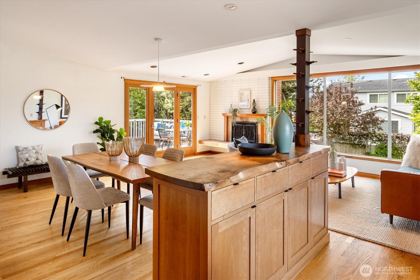 6420 Northeast 60th Street Seattle, WA 98115 - Photo 11 of 40 a kitchen with stainless steel appliances granite countertop a table chairs and a wooden floor