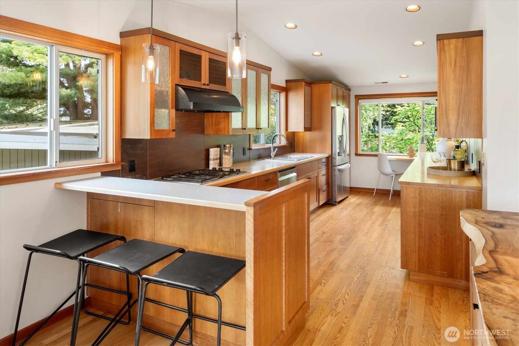 6420 Northeast 60th Street Seattle, WA 98115 - Photo 12 of 40 a kitchen with a sink a stove a dining table and chairs
