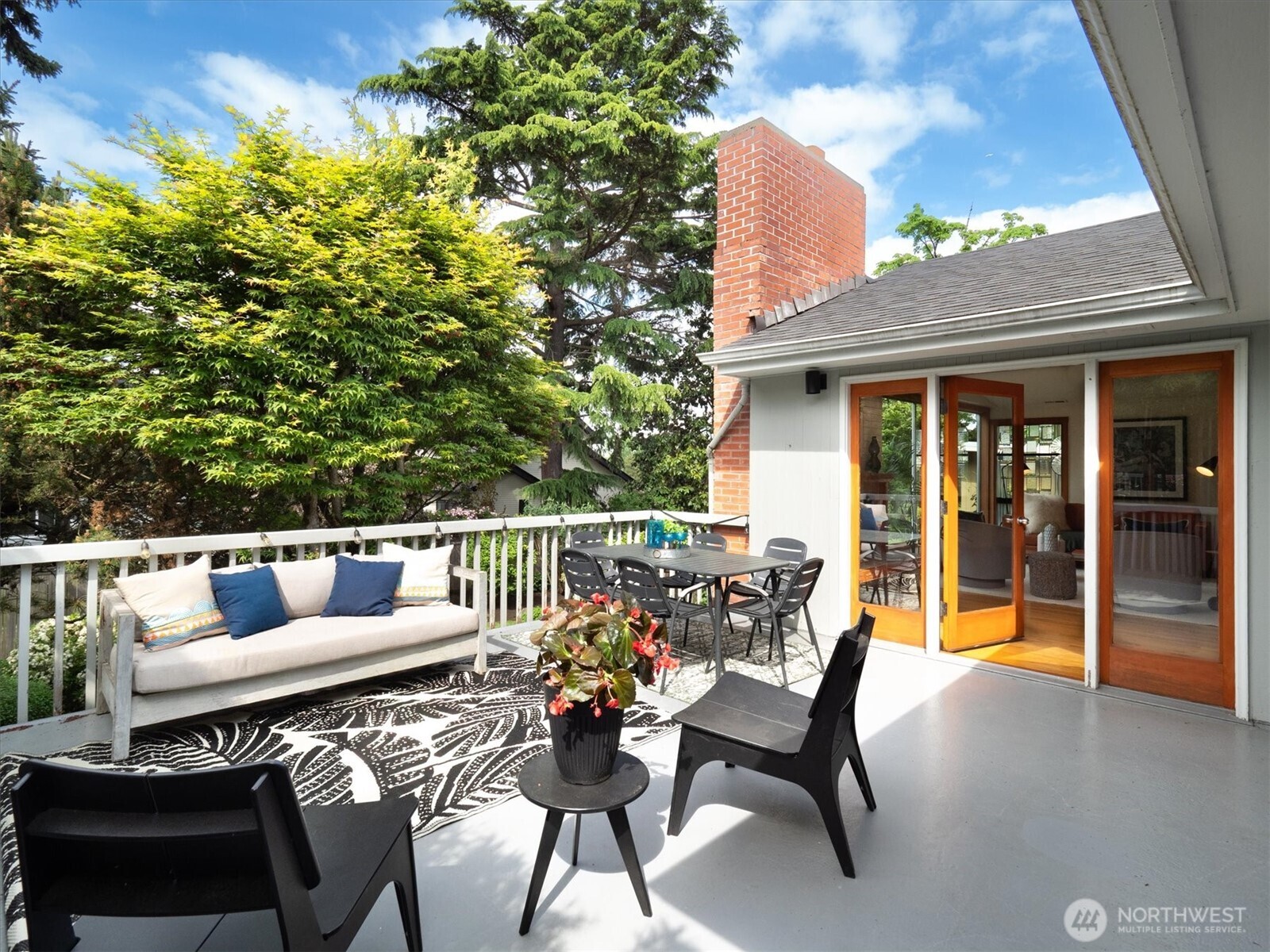 6420 Northeast 60th Street Seattle, WA 98115 - Photo 2 of 40 a view of a patio with couches table and chairs and potted plants