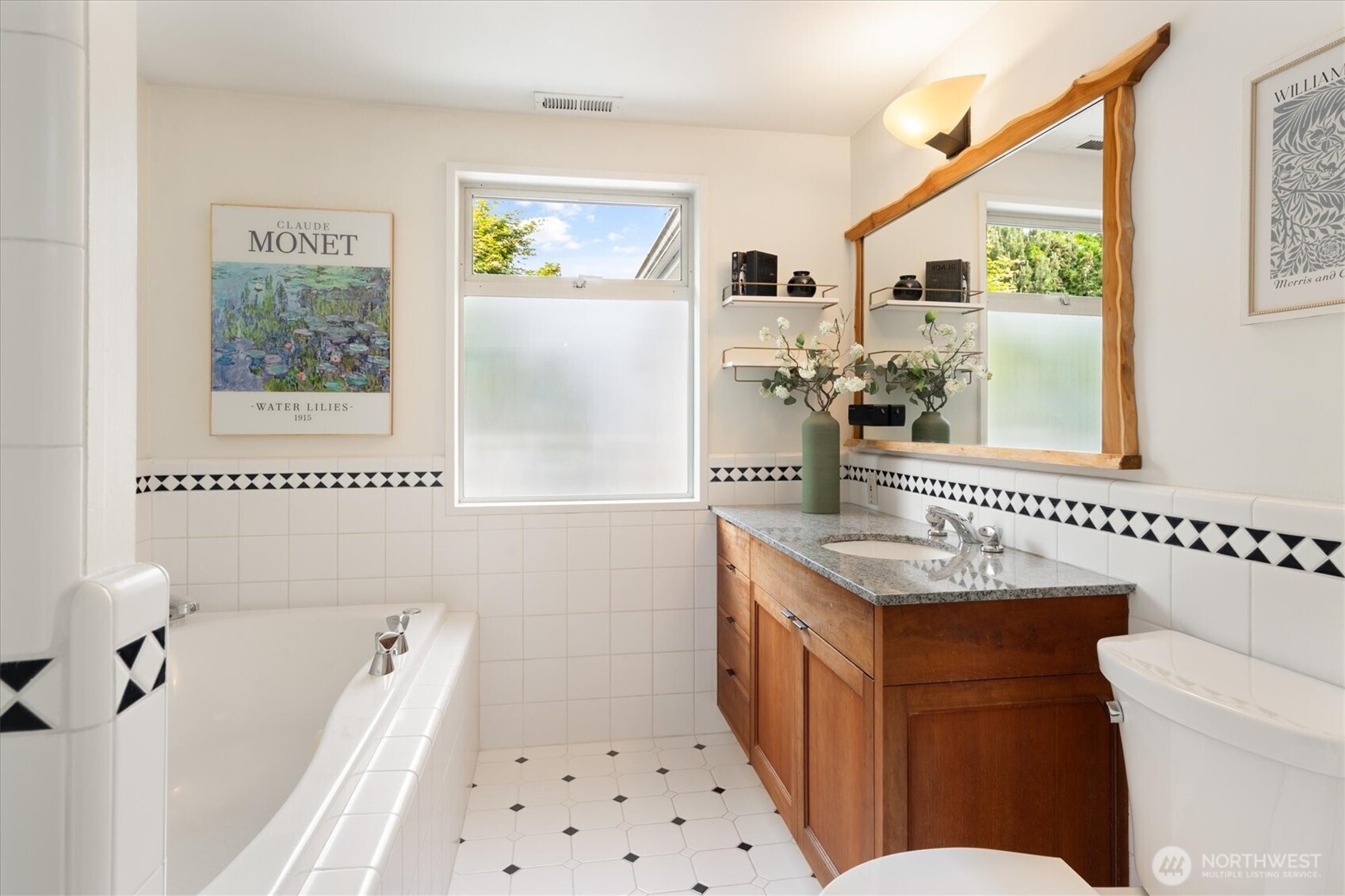 6420 Northeast 60th Street Seattle, WA 98115 - Photo 21 of 40 a bathroom with a sink a toilet a mirror and a window