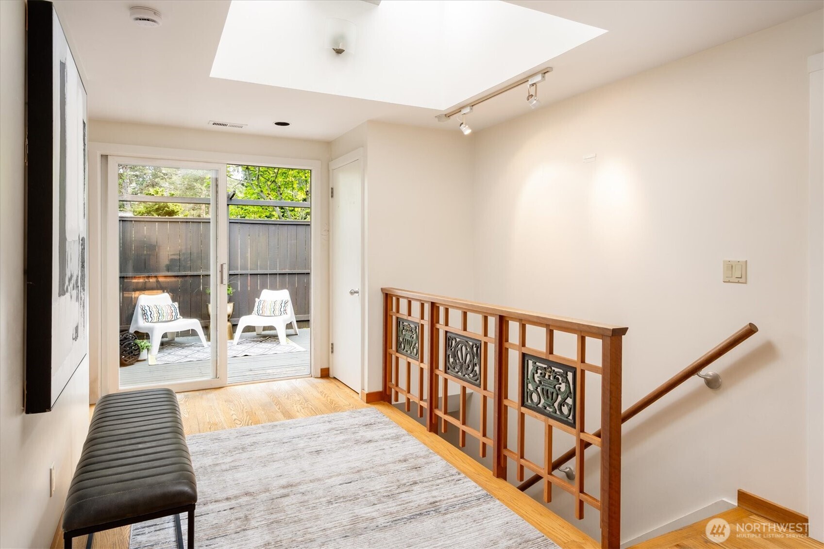 6420 Northeast 60th Street Seattle, WA 98115 - Photo 5 of 40 a view of a hallway with wooden floor and windows