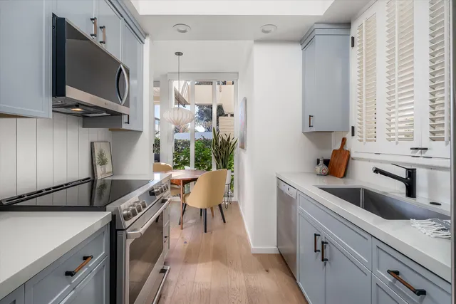 a front view of a house with a garden and lake view