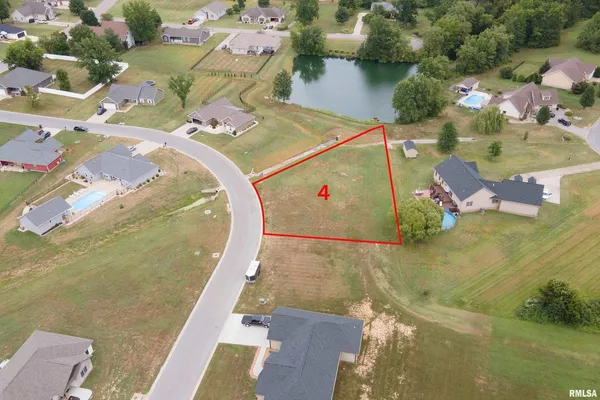 an aerial view of a house with outdoor space and lake view